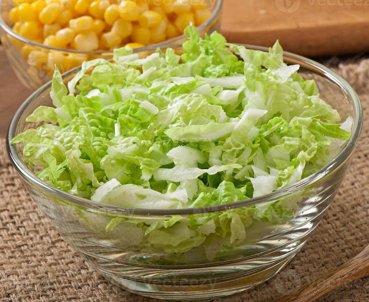 Chinese cabbage salad with sweet corn in a glass bowl photo