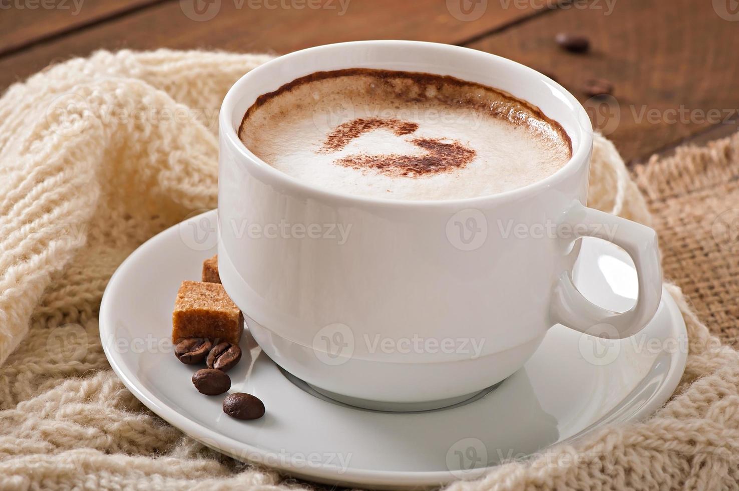 Cup of latte on the old wooden background photo