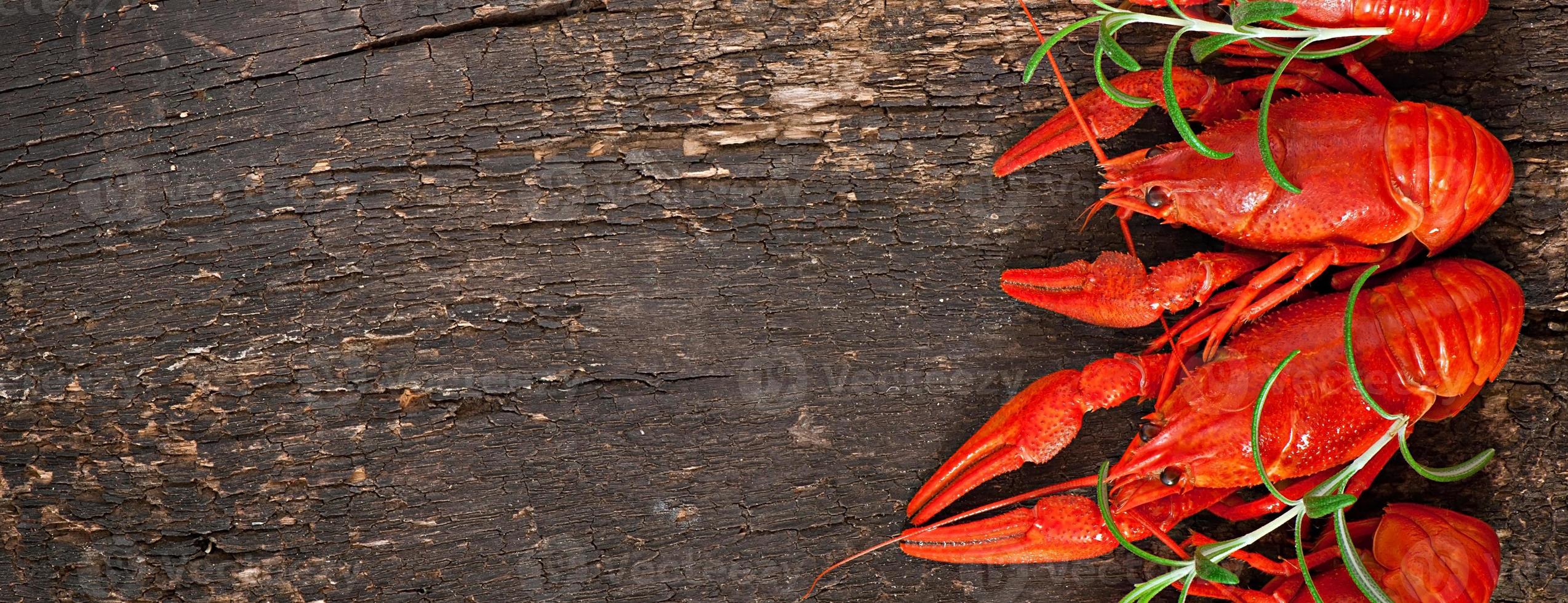 Fresh boiled crawfish on the old wooden background photo