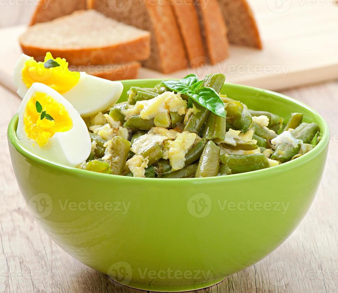 String beans with eggs in bowl. photo