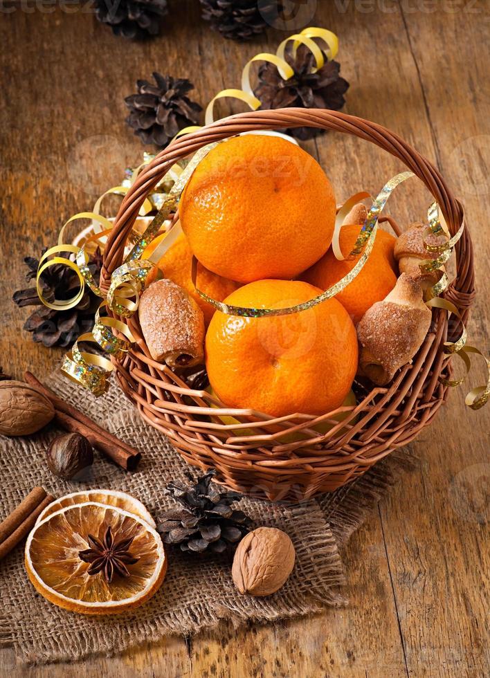 Tangerines and spices on a wooden background photo