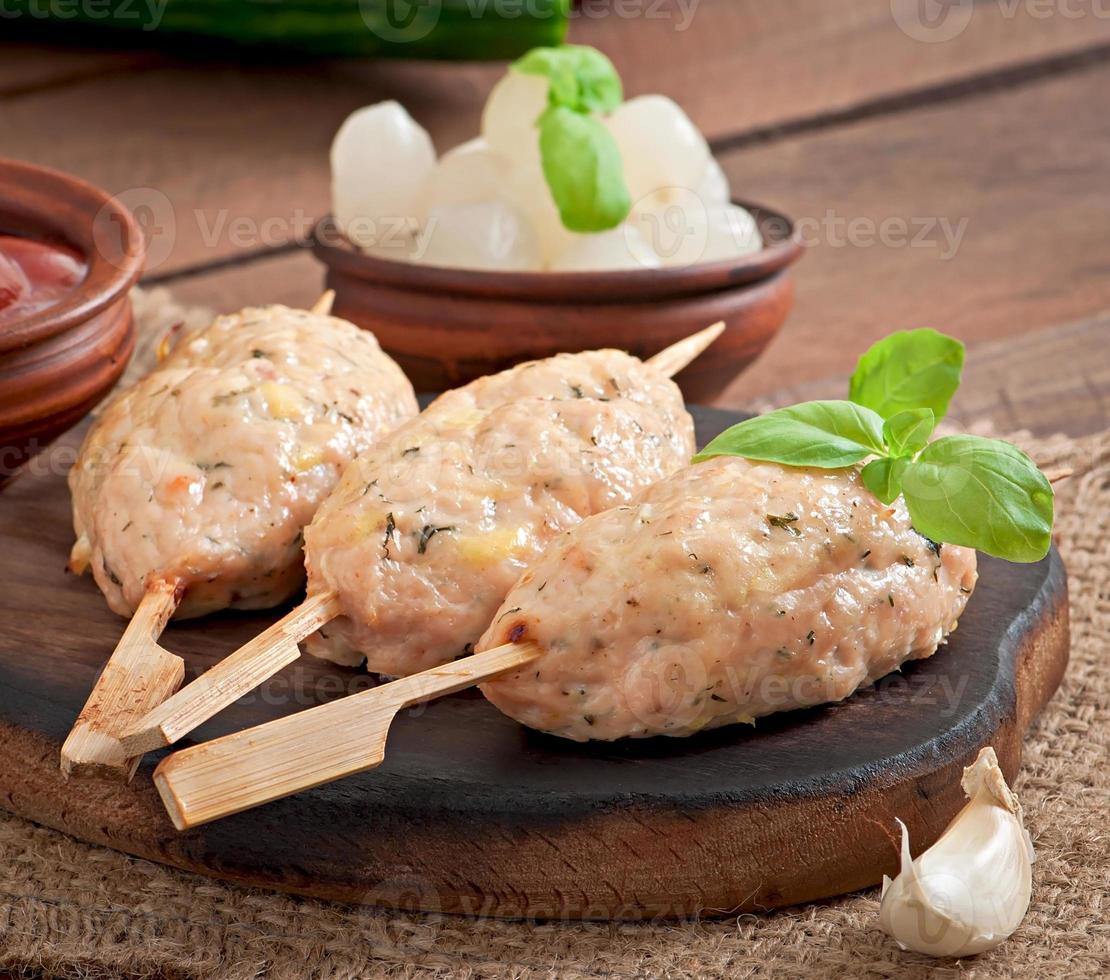 Kebab of minced chicken with dill and parsley photo