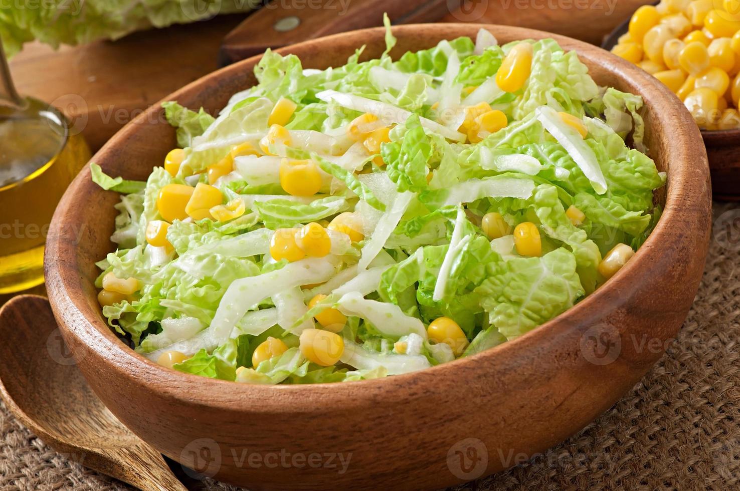 Chinese cabbage salad with sweet corn in a wooden bowl photo