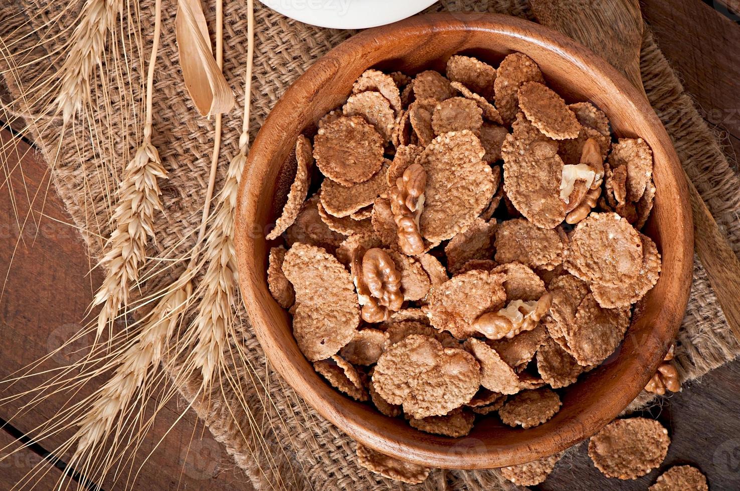 Healthy breakfast - whole grain muesli with a walnut in a wooden bowl photo