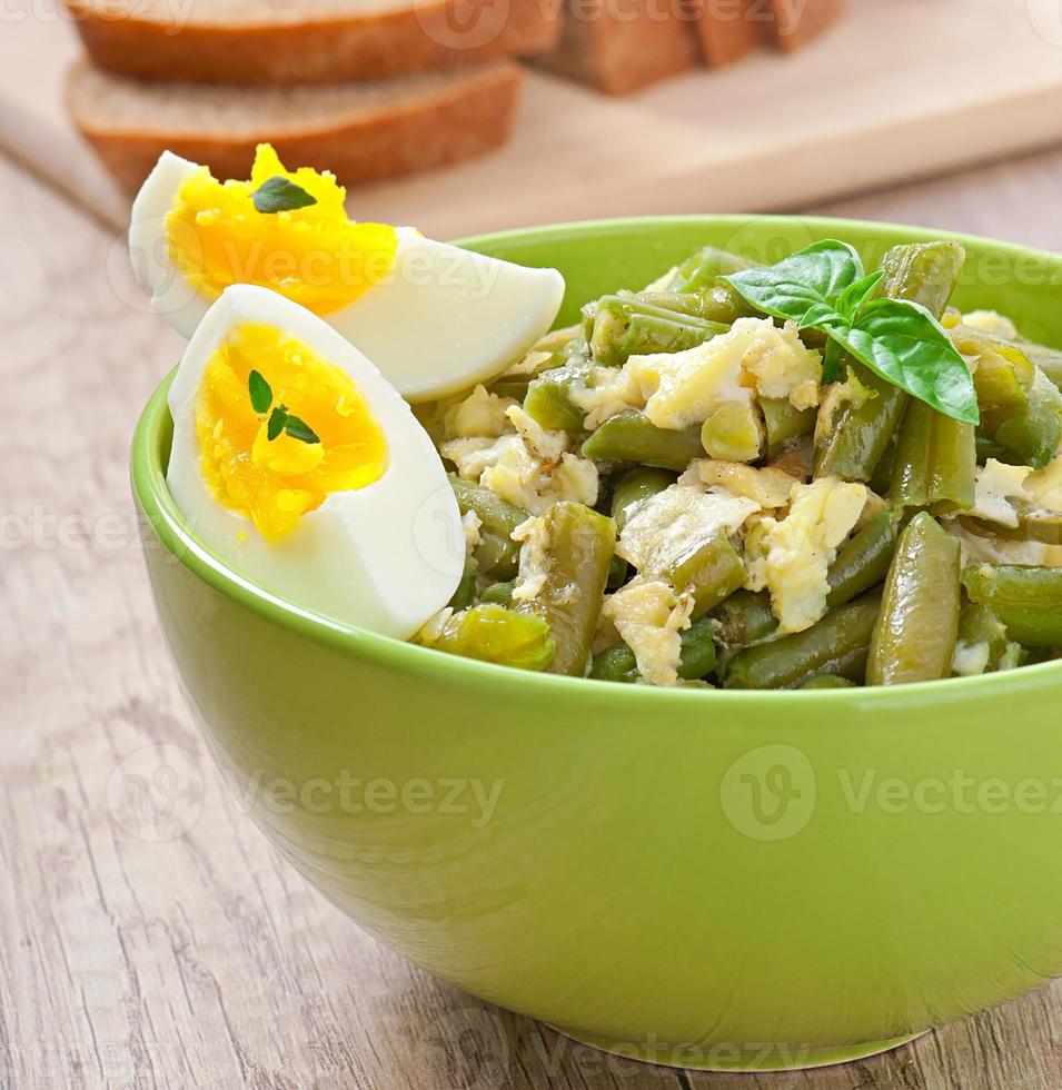 String beans with eggs in bowl. photo