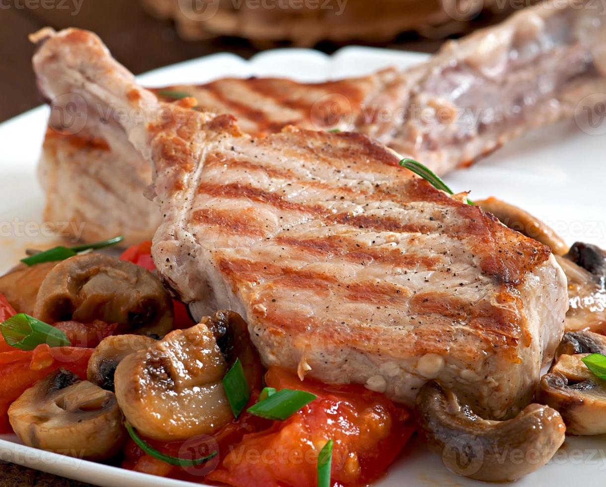 Juicy grilled pork steak on the bone photo