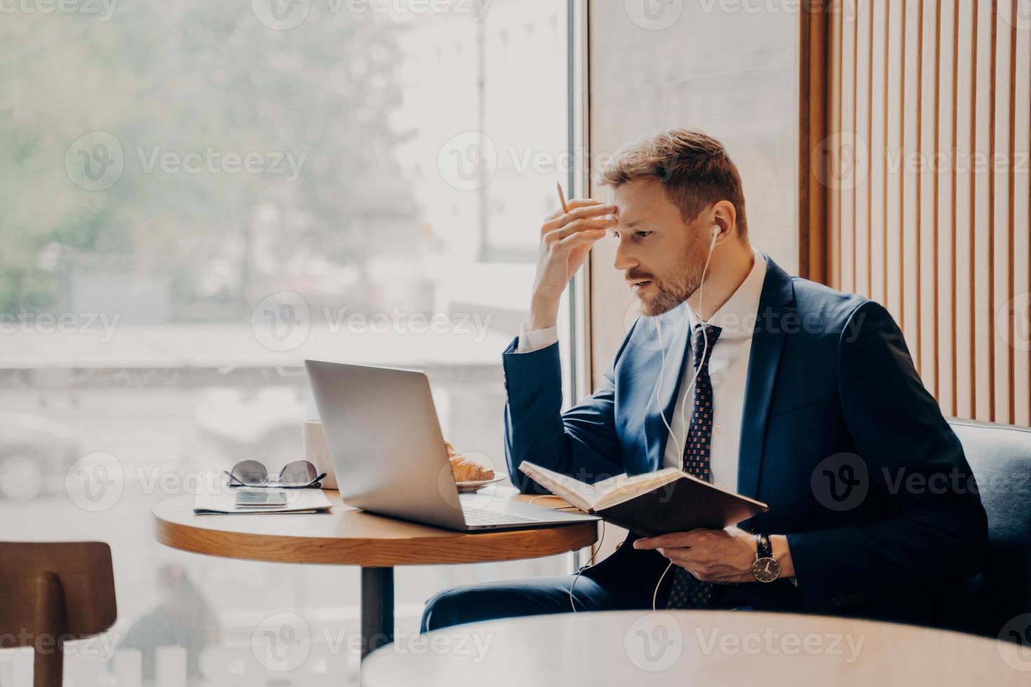 Side photo of successful business person busy working from coffee shop