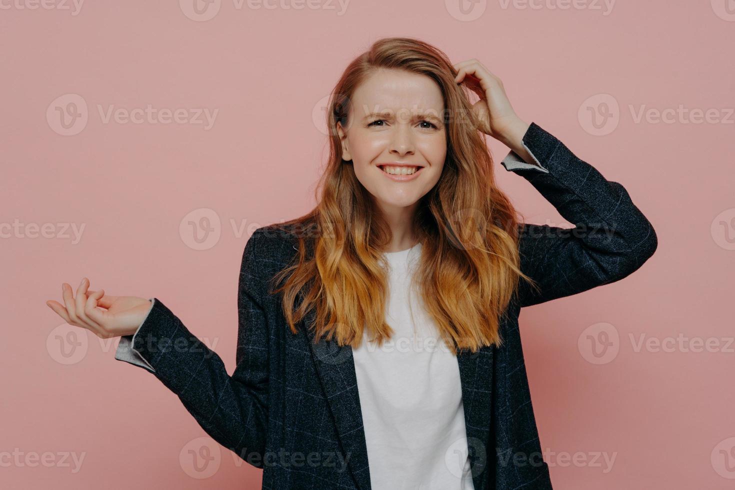 Smiling young woman can not believe what she hearing or seeing photo