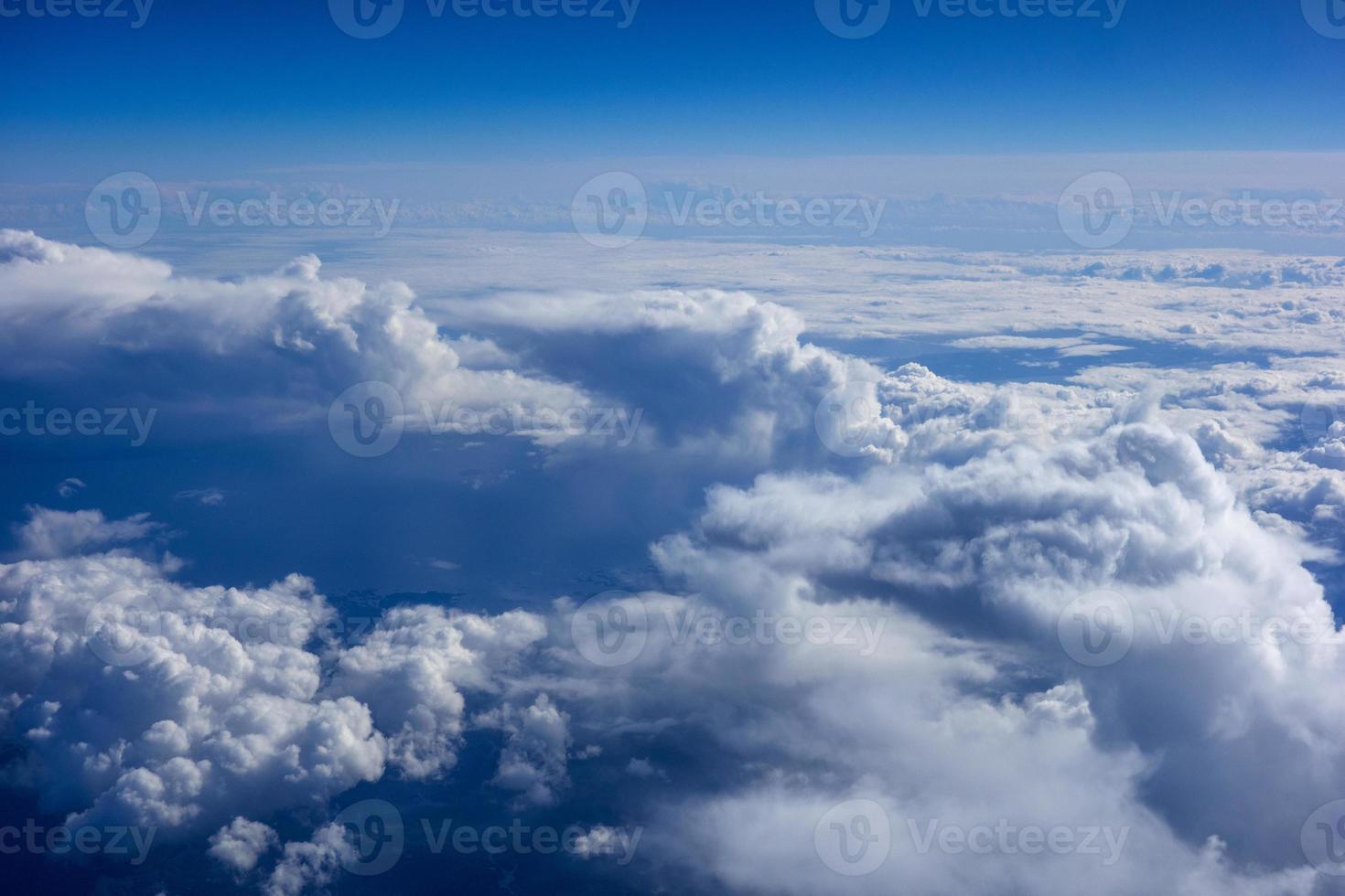 White fluffy clouds in a bright blue sky photo