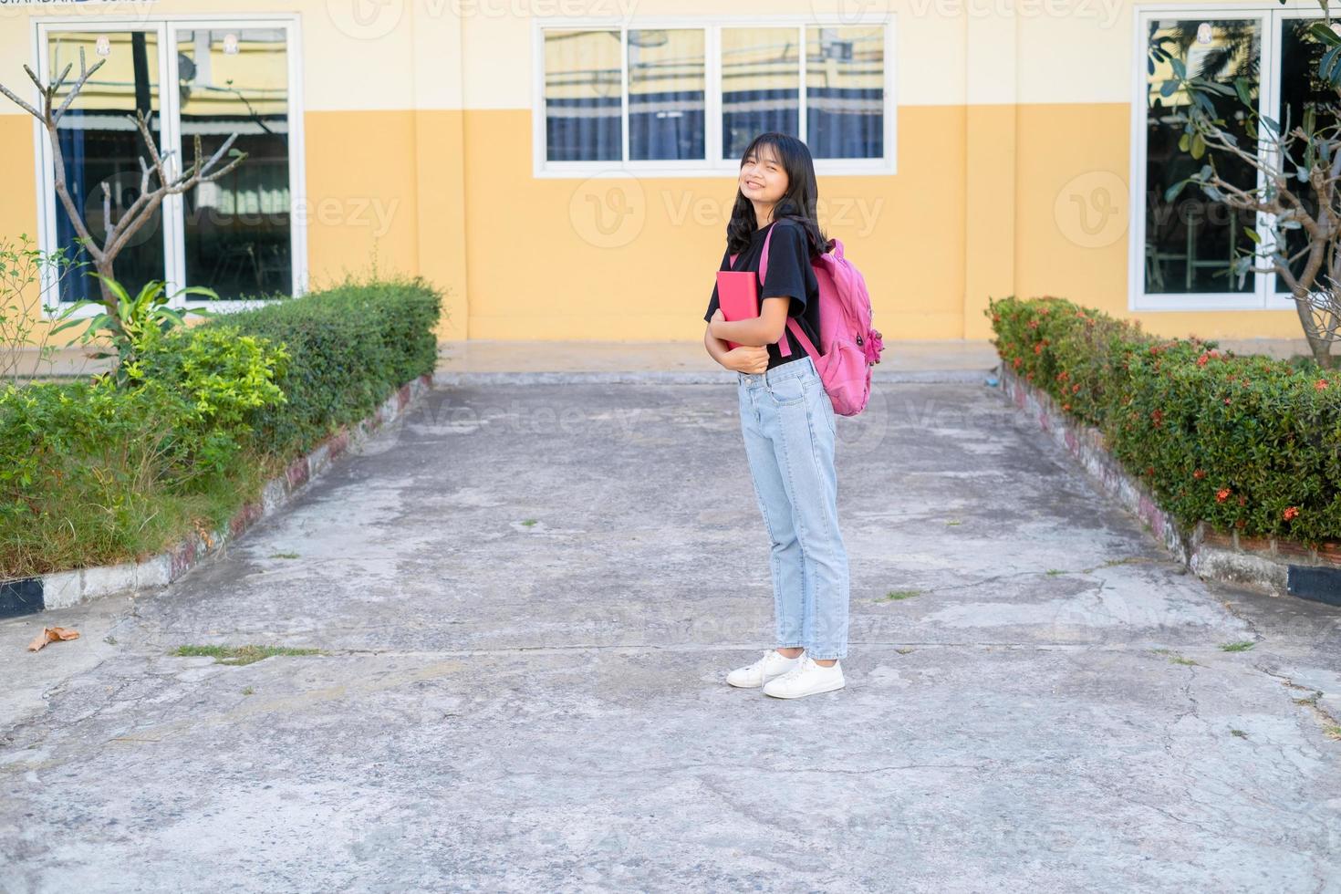 Happy girl standing at school. photo