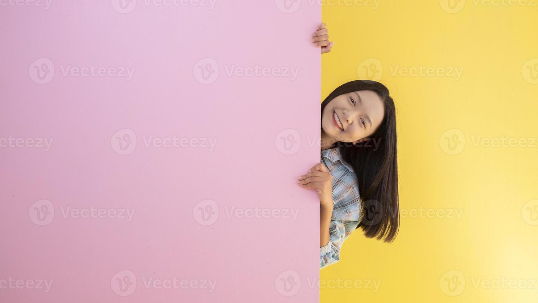 Happy student young girl with pink and yellow background. photo
