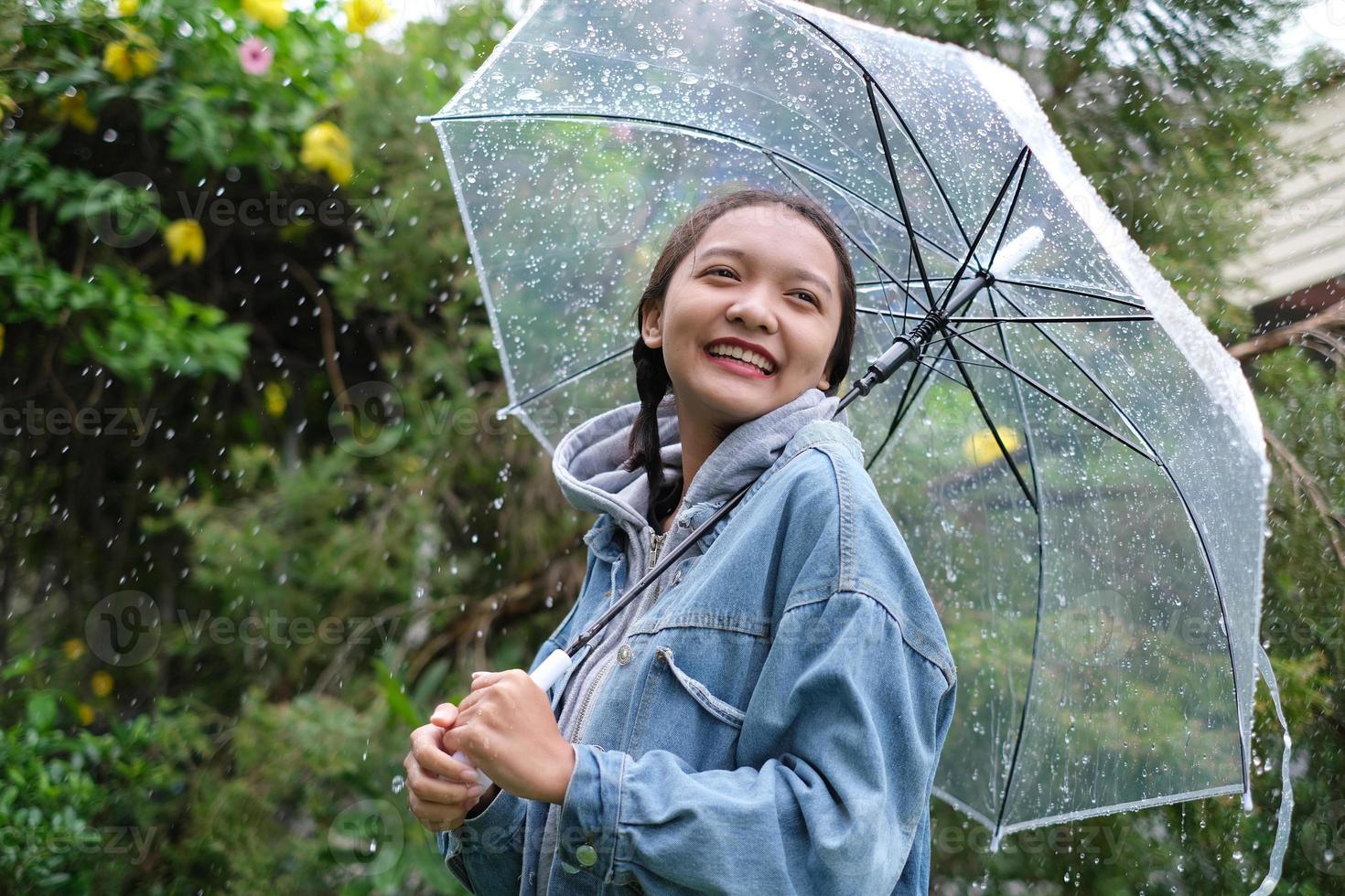 Smile young girl having fun in rainy. photo