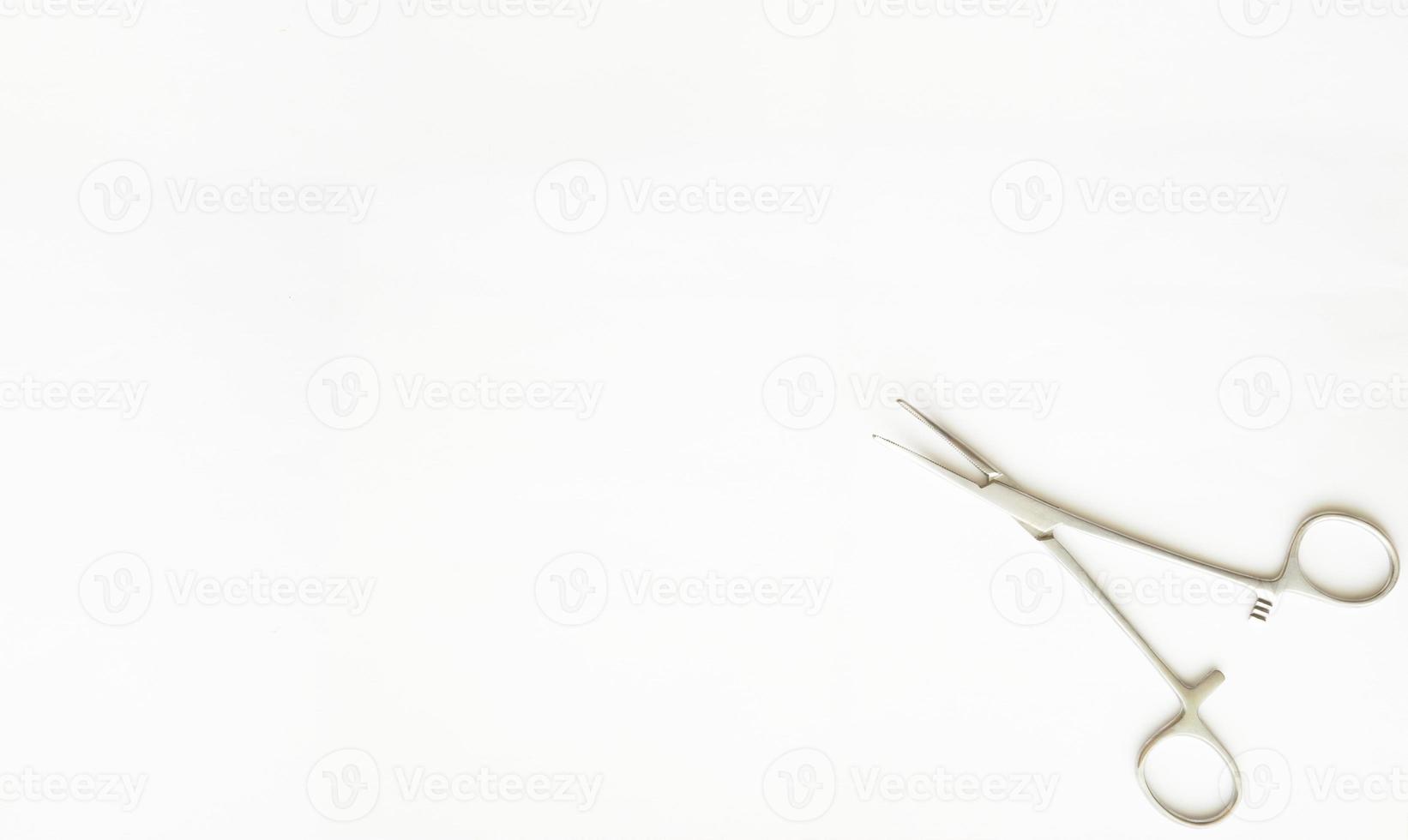 cramp forceps on corner of white copy space photo
