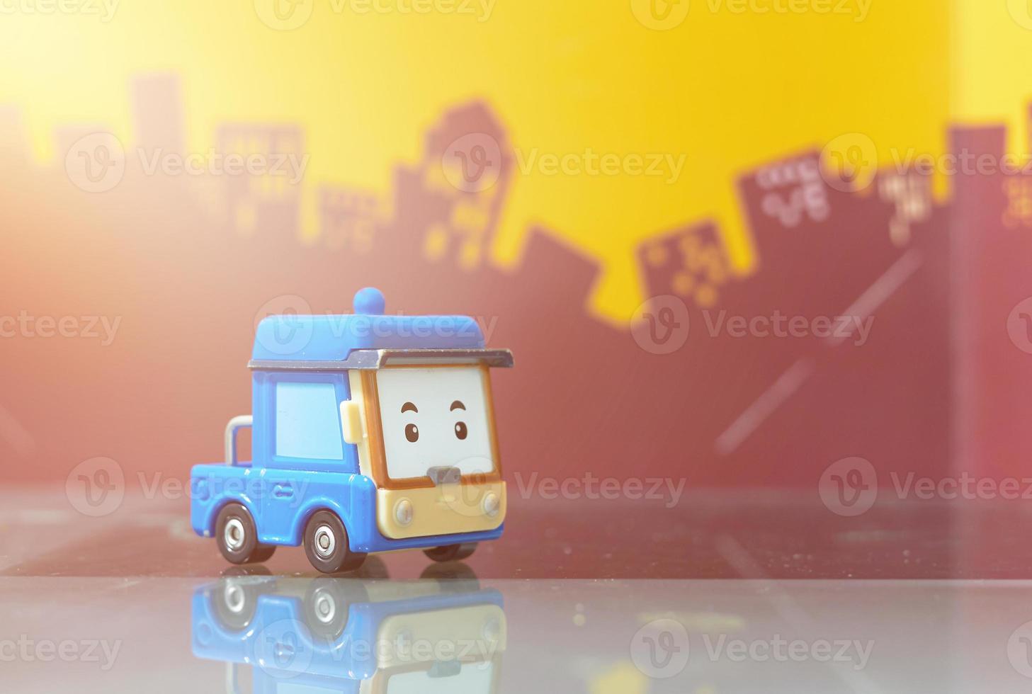 blue cartoon car toy selective focus on blur city background photo