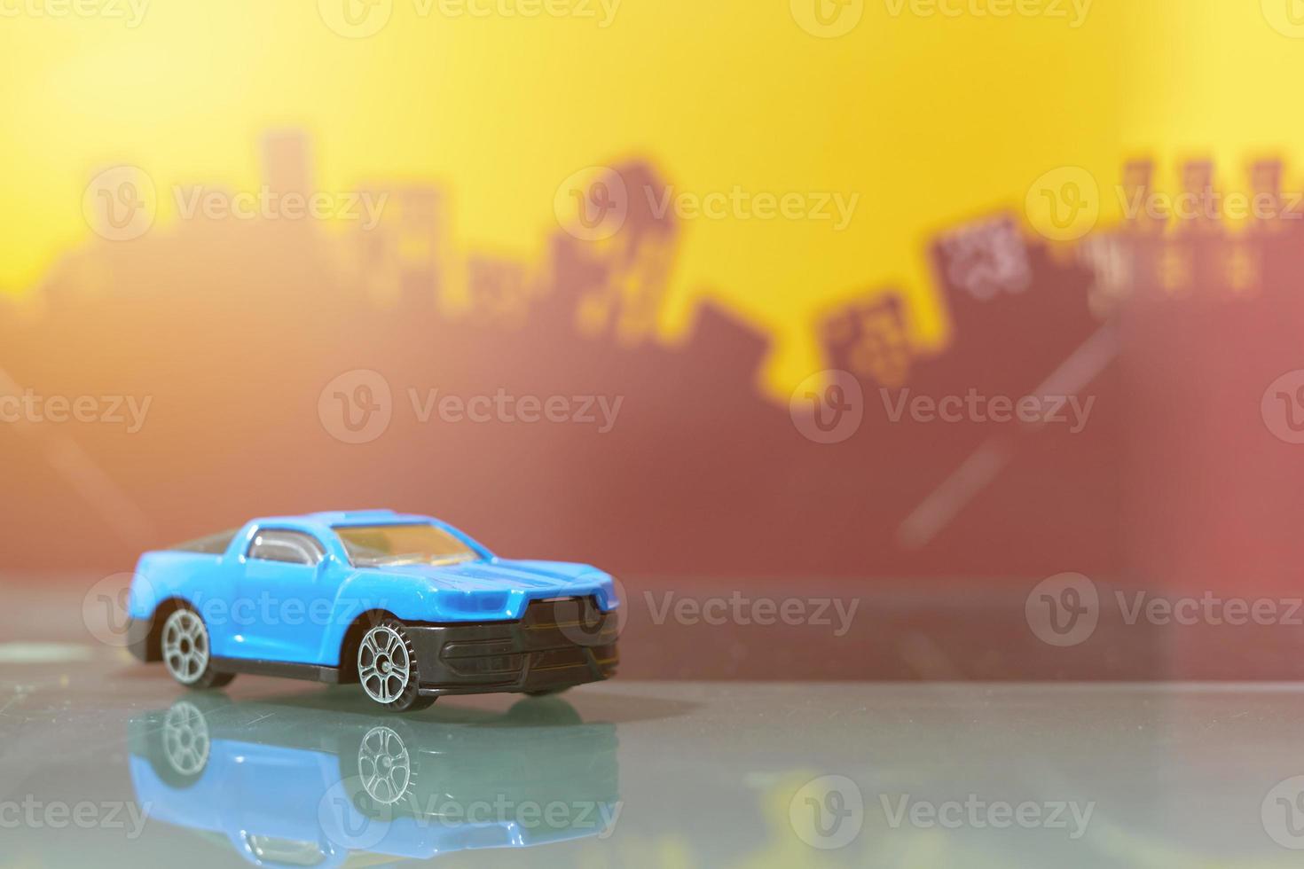 blue muscle car toy selective focus on blur city background photo
