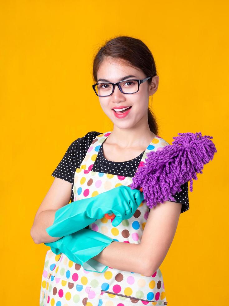 Asian beautiful woman holding a dusting to clean the device photo