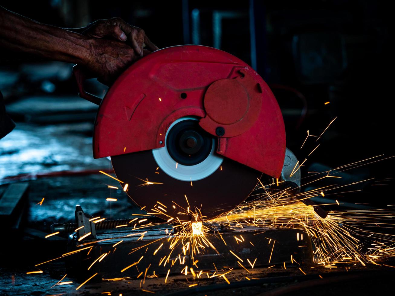 Professional technicians in the factory are using power tools to cut the metal photo