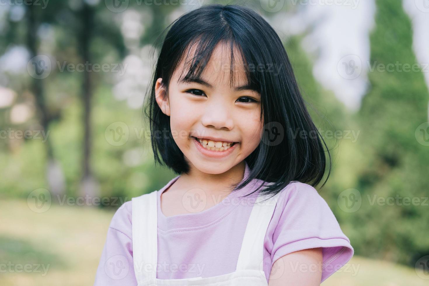 Portrait of Asian little girl playing in the park photo