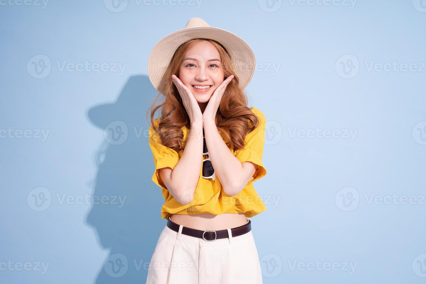 Portrait of young Asian girl on blue background, summer vacation concept photo