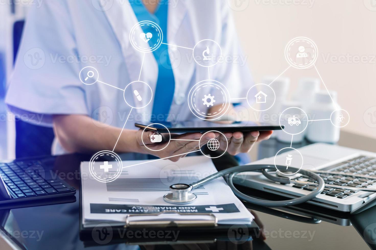 Medical technology concept. Doctor working with mobile phone and stethoscope and digital tablet laptop in modern office photo