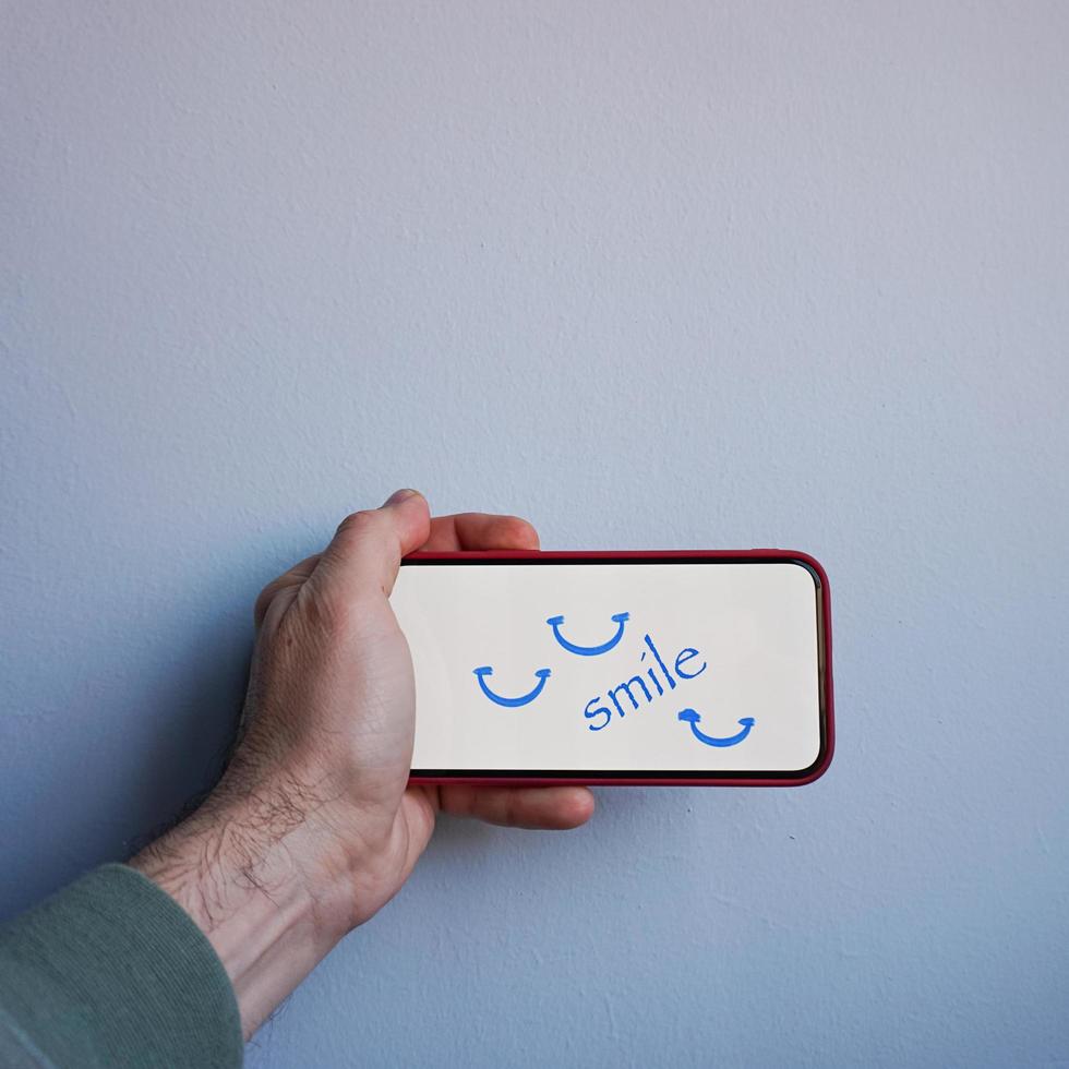word smile on the phone, feelings and emotions photo