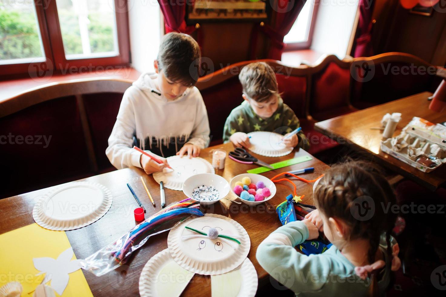 Preparing to Easter concept. Kids making by hands bunny and eggs. photo