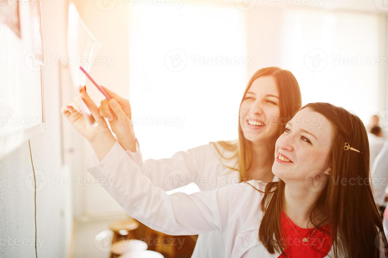 Skillful doctors are looking at x-ray image of their patient's body part in the hospital. photo