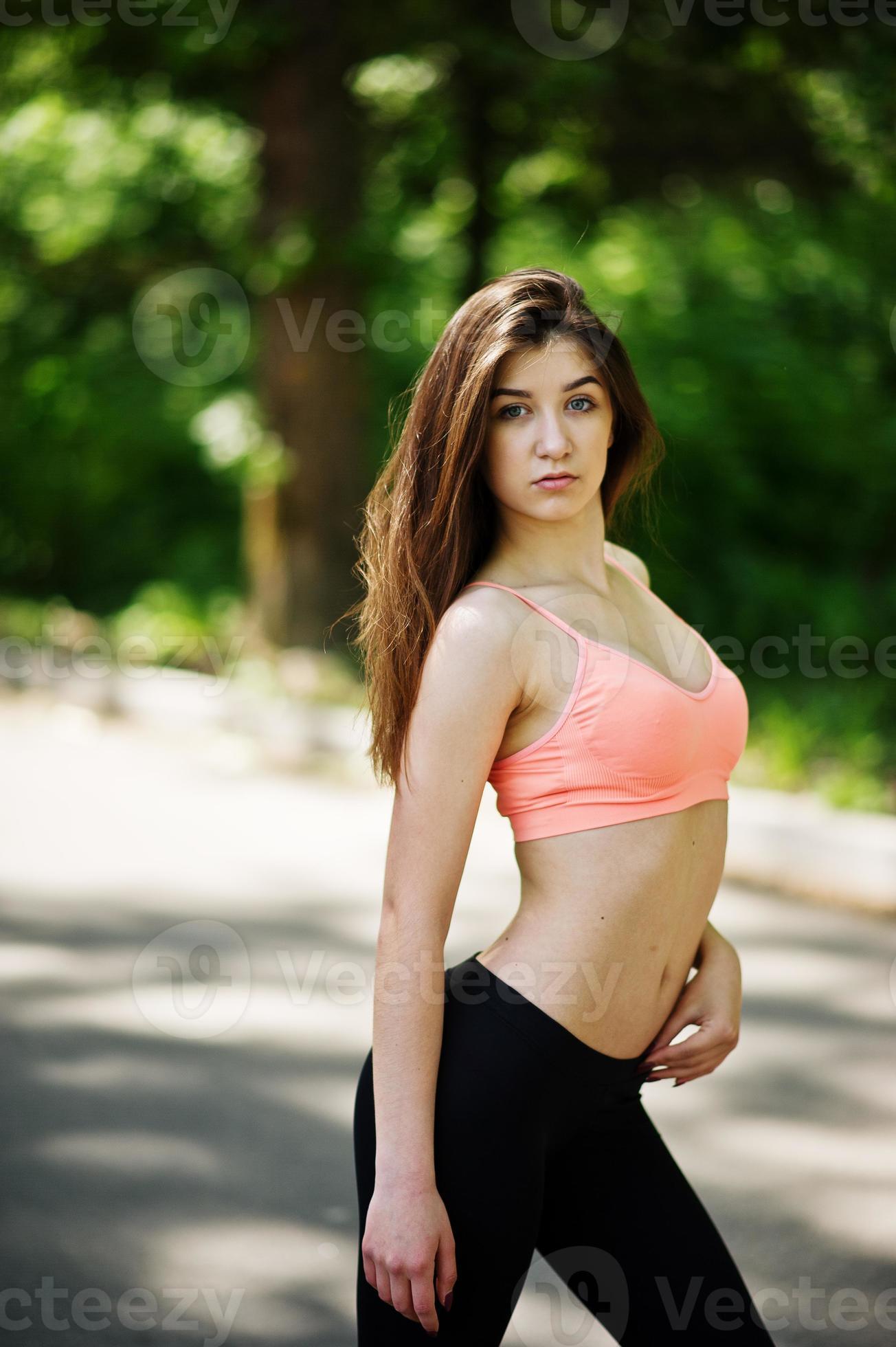 Fitness slim sexy sport girl in sportswear posed in road at park