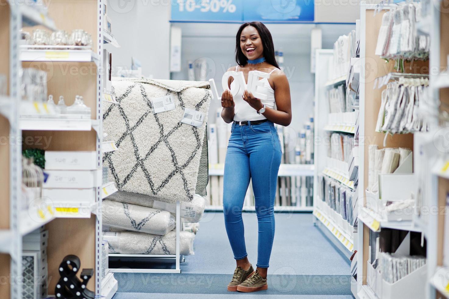 Attractive african american woman holding love letters in her hands in the shop. photo