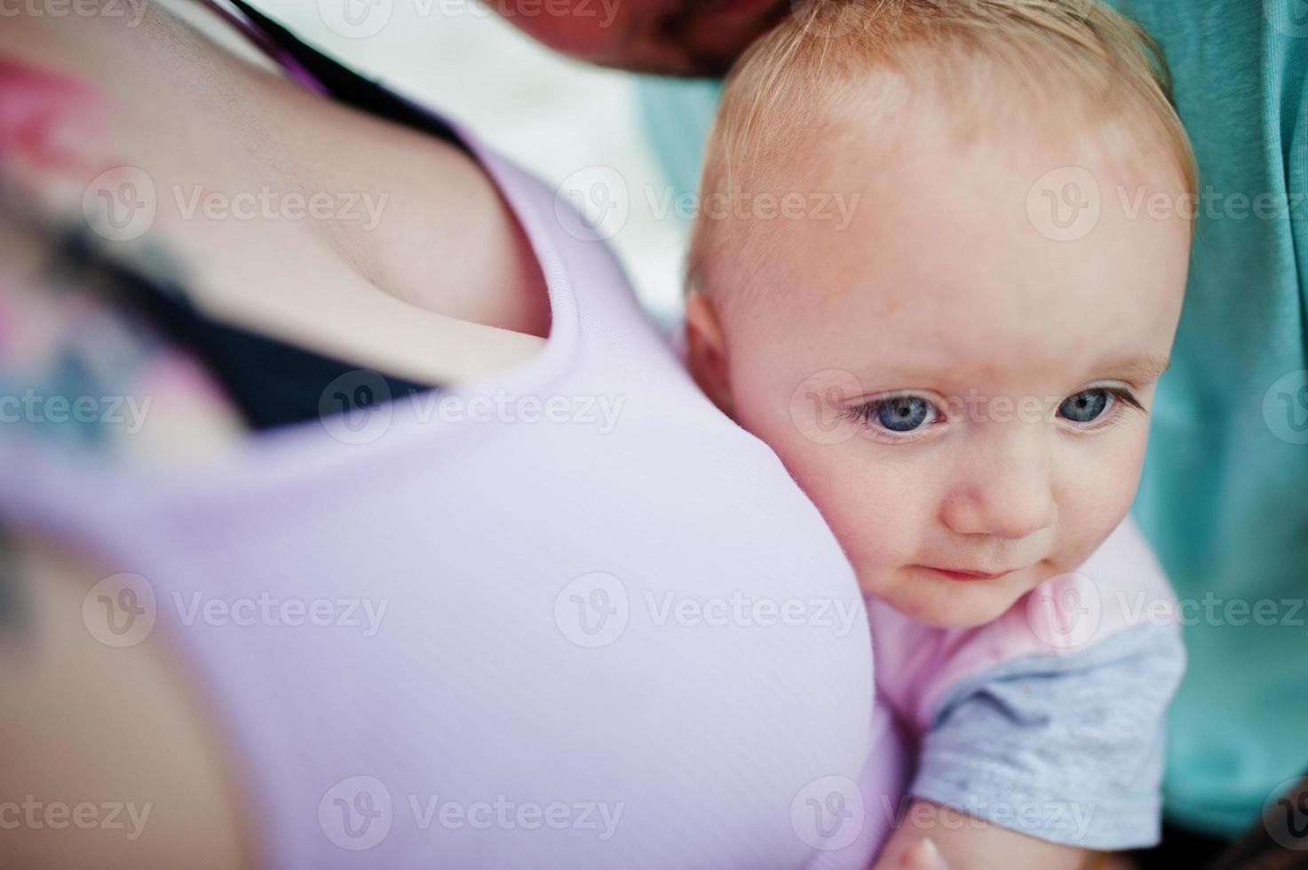 Summer vacations. Parents and people outdoor activity with children. Happy family holidays. Father, pregnant mother, baby daughter on sea sand beach. photo