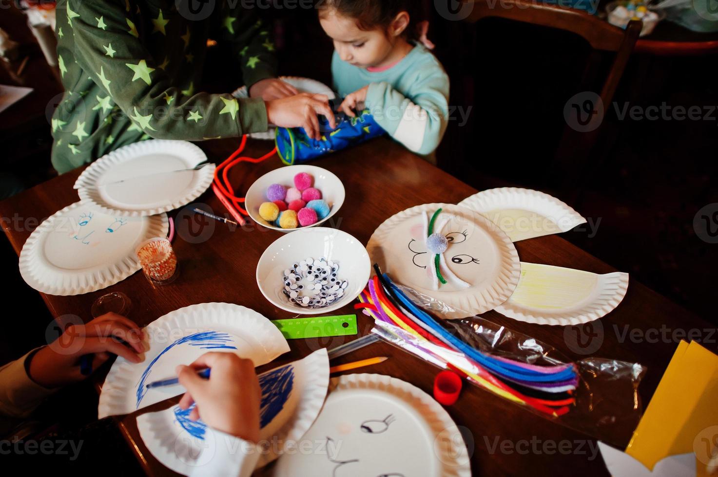 Preparing to Easter concept. Kids making by hands bunny and eggs. photo