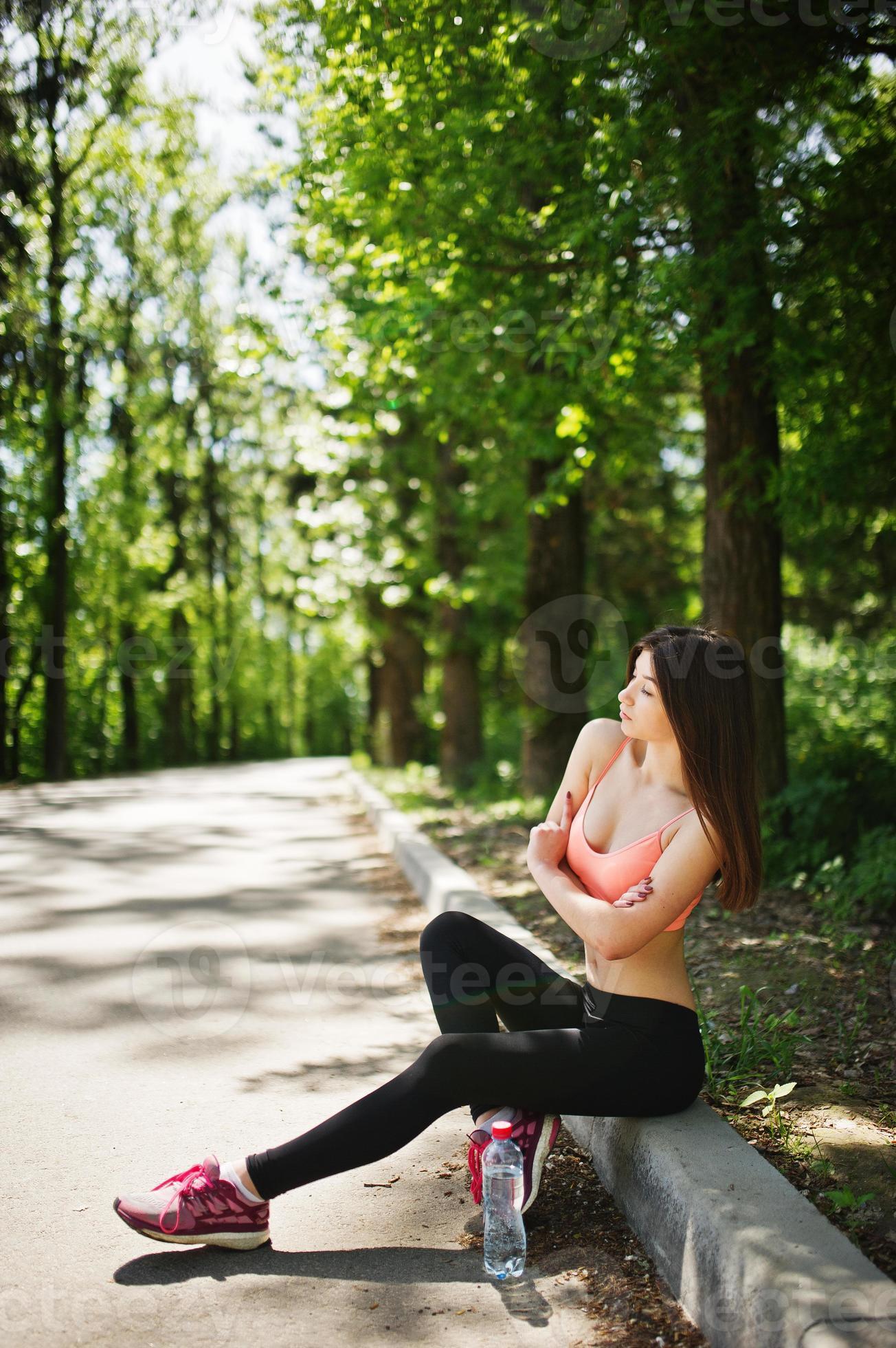 Fitness slim sexy sport girl in sportswear posed in road at park