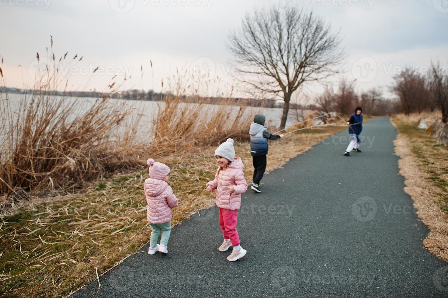 Children run on the path by the lake. photo