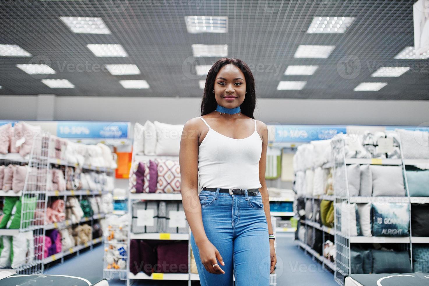 Portrait of a fantastic woman with african american heritage walking in the store. photo