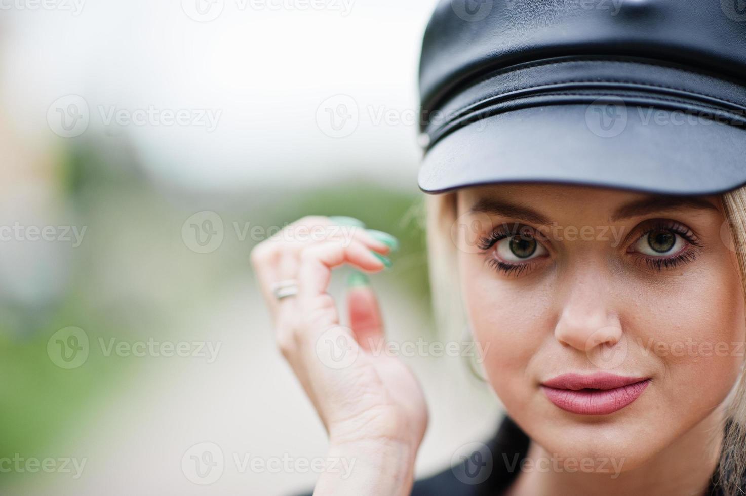 Close up portrait of beautiful blonde sexy fashion woman model in cap and in all black with bright makeup. photo