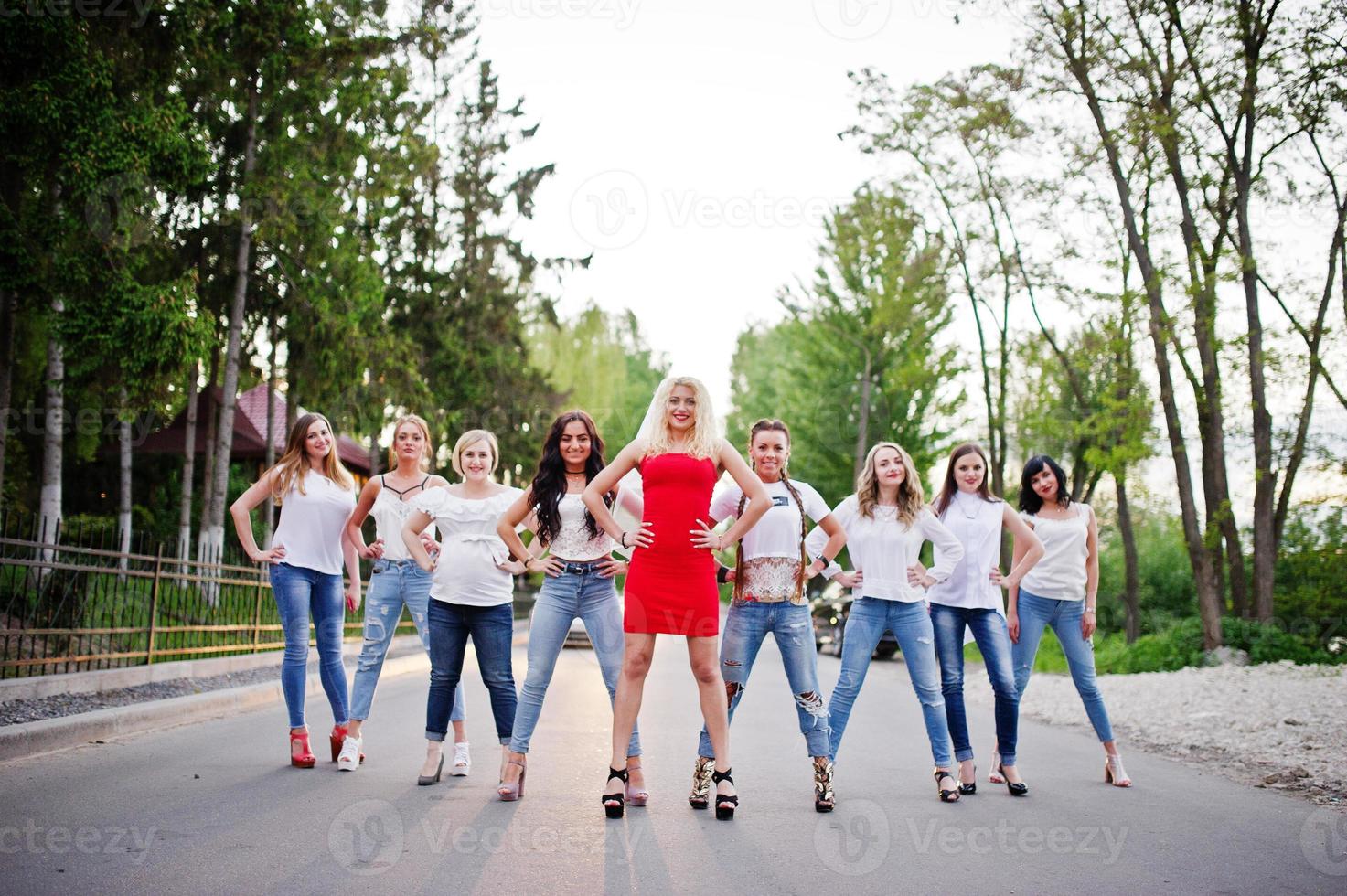 Girls having fun while posing outside in the park on the bachelorette party. photo