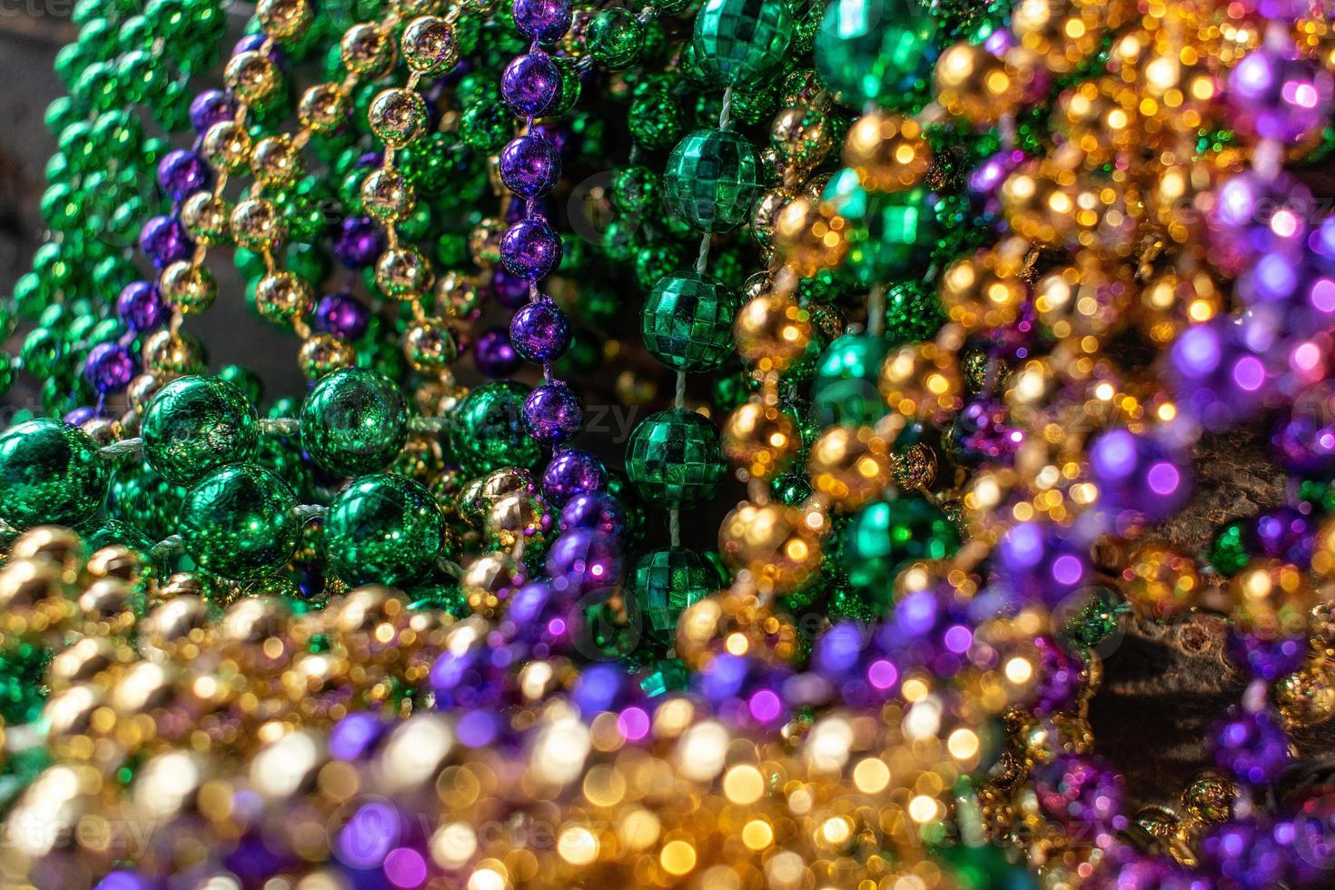 mardi gras beads with bokeh in green, gold, and purple photo