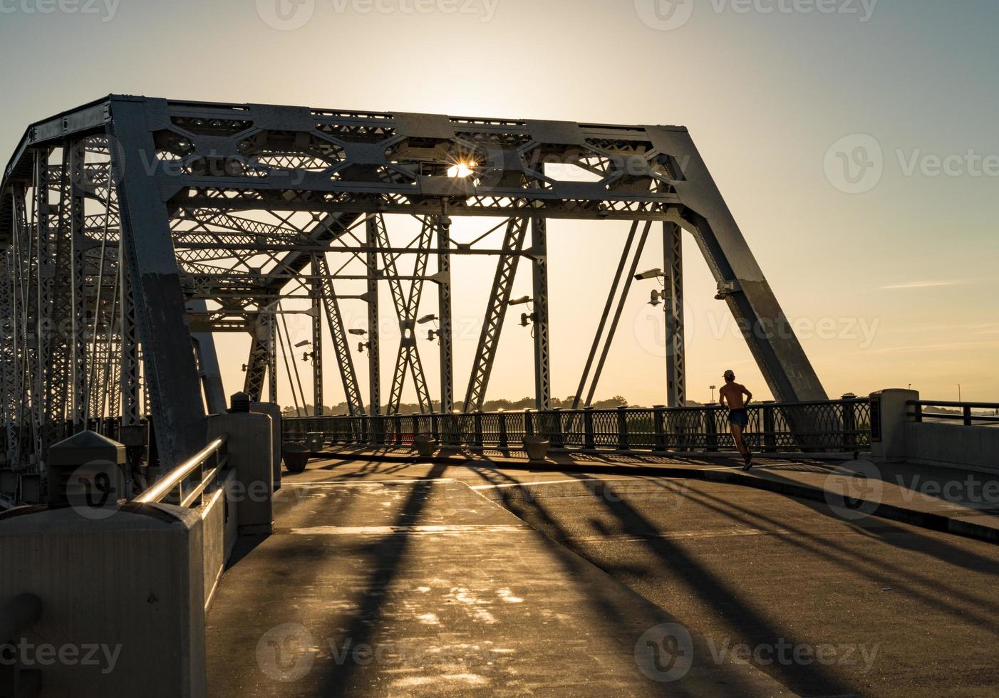 Runner on John Seigenthaler pedestrian bridge or Shelby street crossing at sunrise in Nashville photo