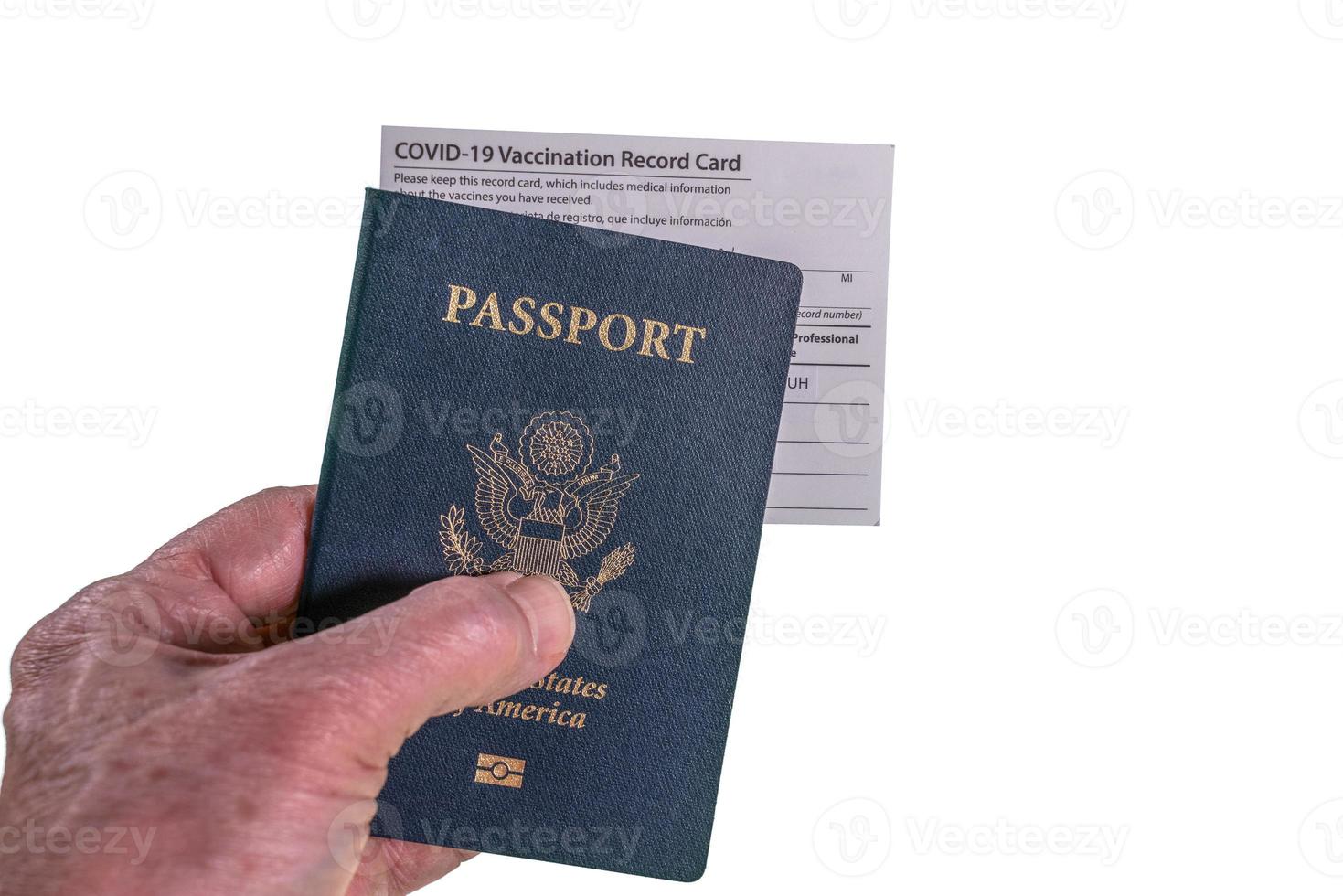 Senior man holding Covid-19 vaccination record certificate and US passport to show immunity to virus for travel photo