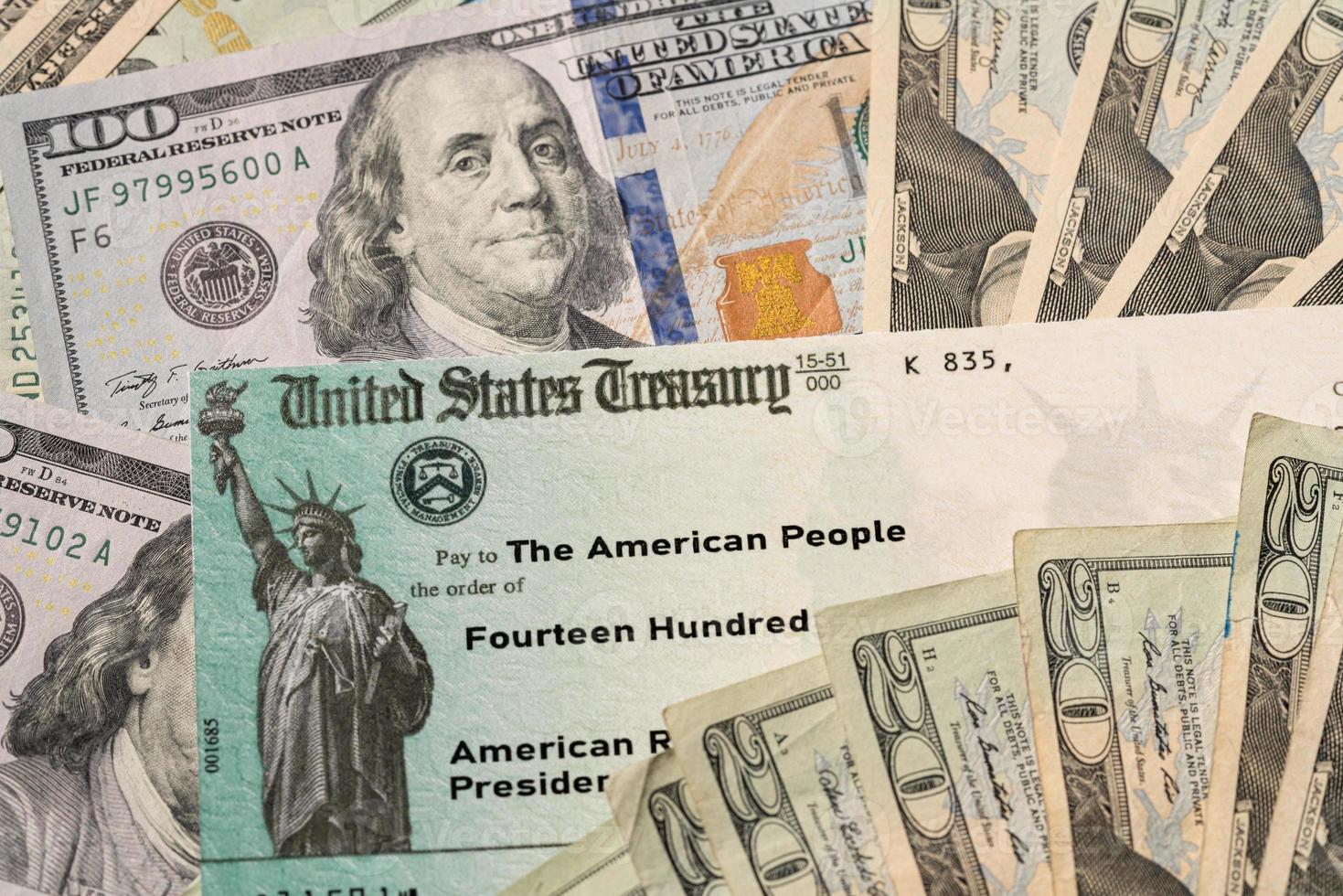 Illustration of the 2021 federal stimulus payment check from the IRS with cash photo