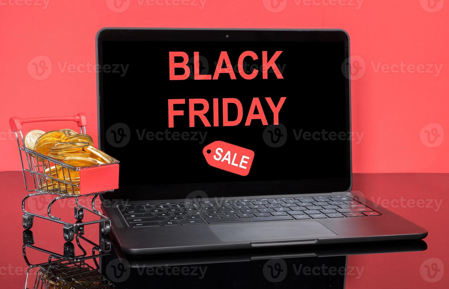 Modern laptop computer with Black Friday sale screen with shopping cart and gold coins photo