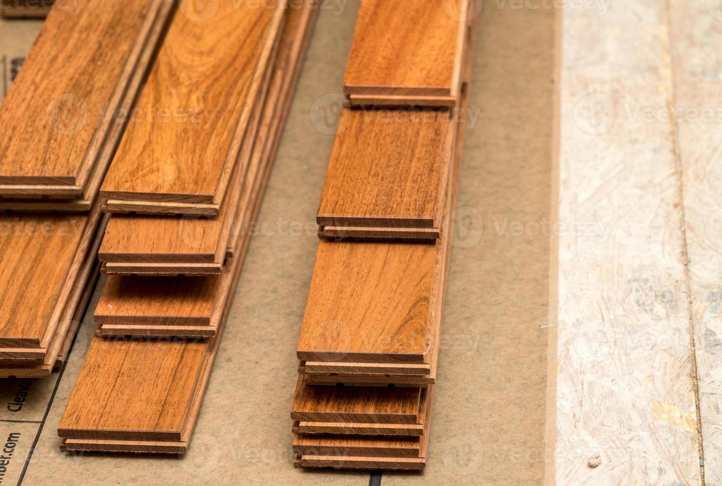 Stack of planks of brazilian Cherry hardwood flooring pieces ready for installation photo