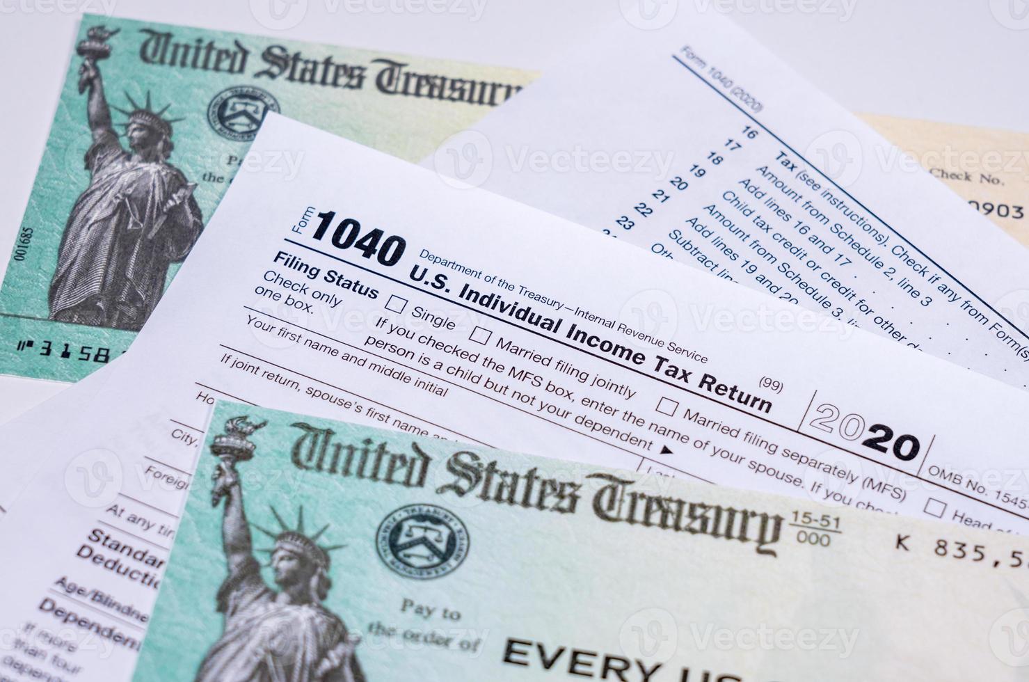 US Treasury check for stimulus in 2020 against a USA Form 1040 photo