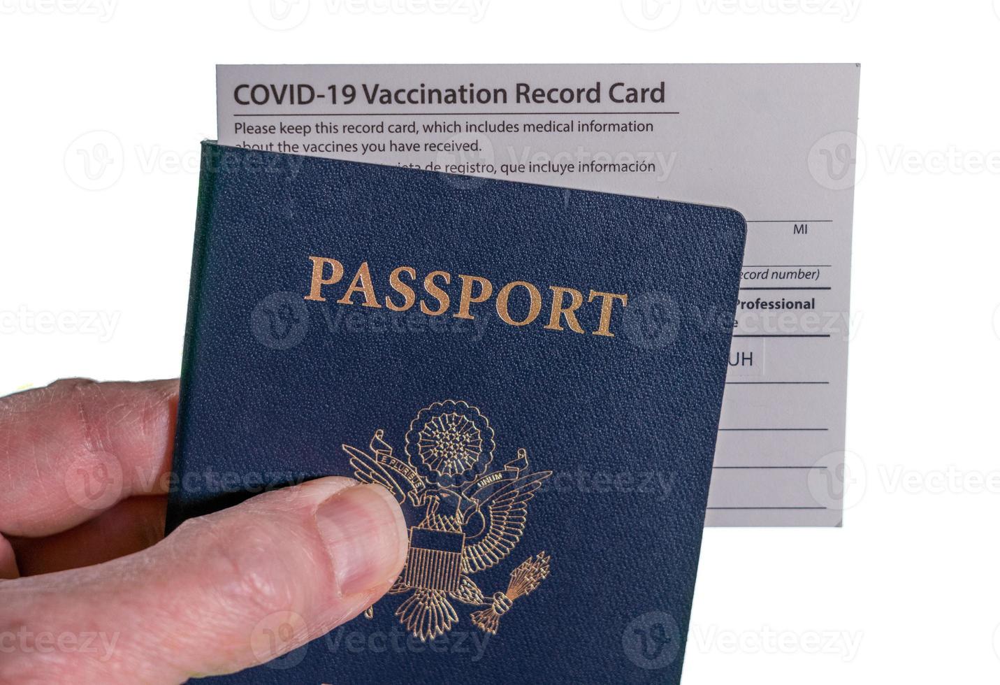 Senior man holding Covid-19 vaccination record certificate and US passport to show immunity to virus for travel photo