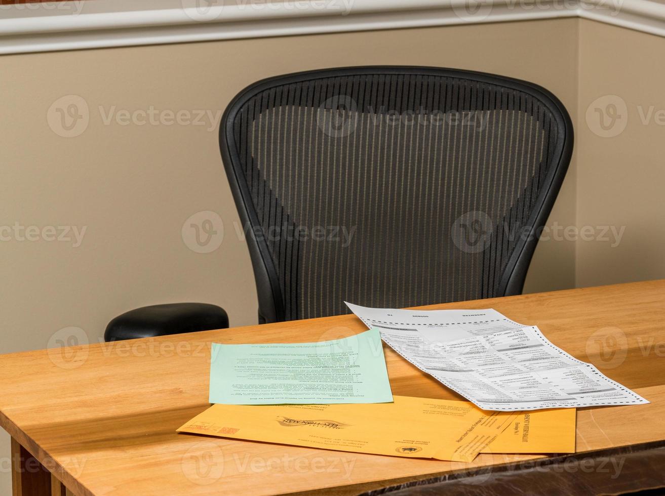 Empty desk at home with the paperwork for completing absentee voting ballot in Presidential election photo