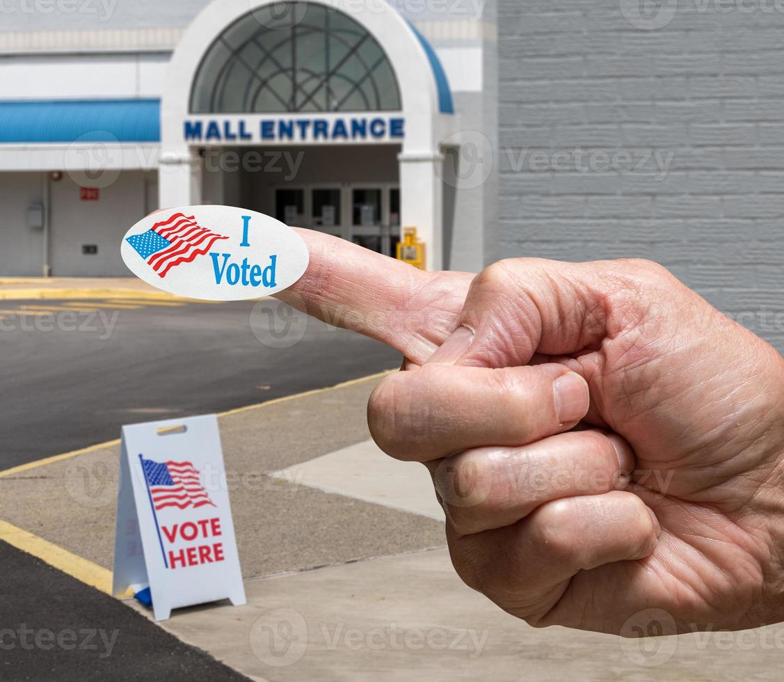 Hand with sticker by entrance to a polling place for elections in old Mall photo