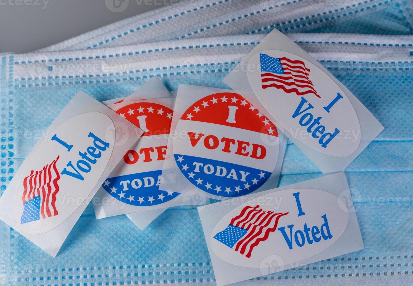 I Voted Today paper sticker on medical face mask to illustrate in person voting photo