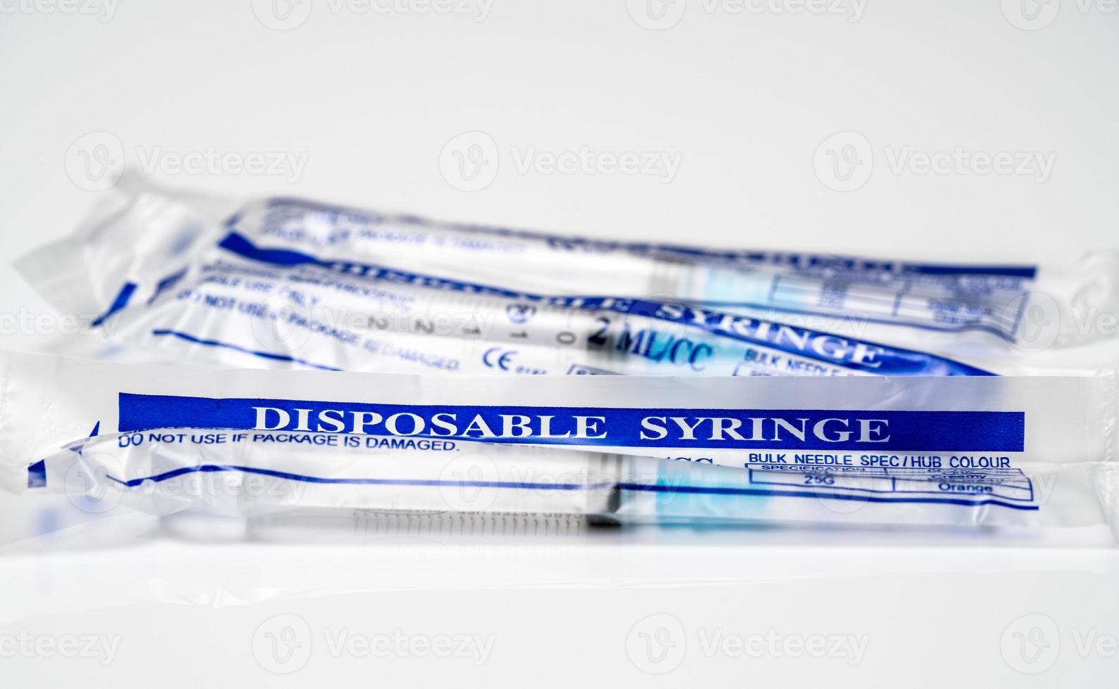 Concept for Covid-19 booster dose or shot using three wrapped disposable syringes photo