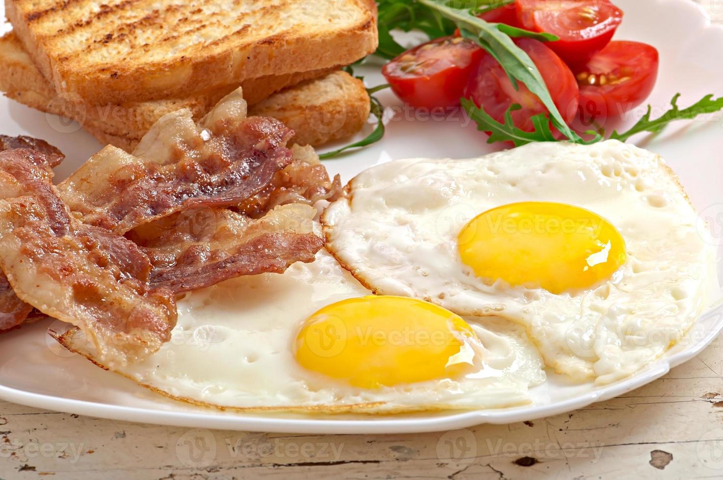 English breakfast - toast, egg, bacon and vegetables photo
