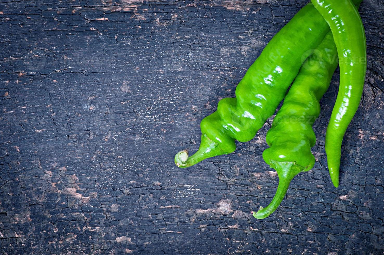 Green chili peppers on  background photo